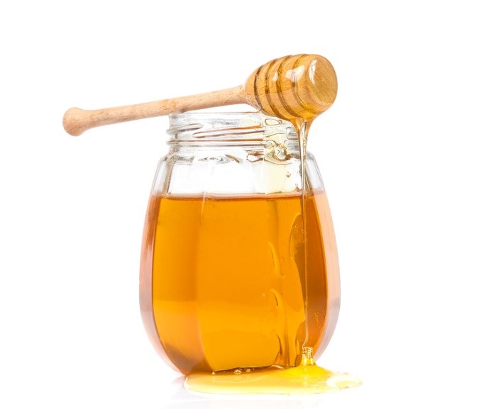 honey with a wooden stick