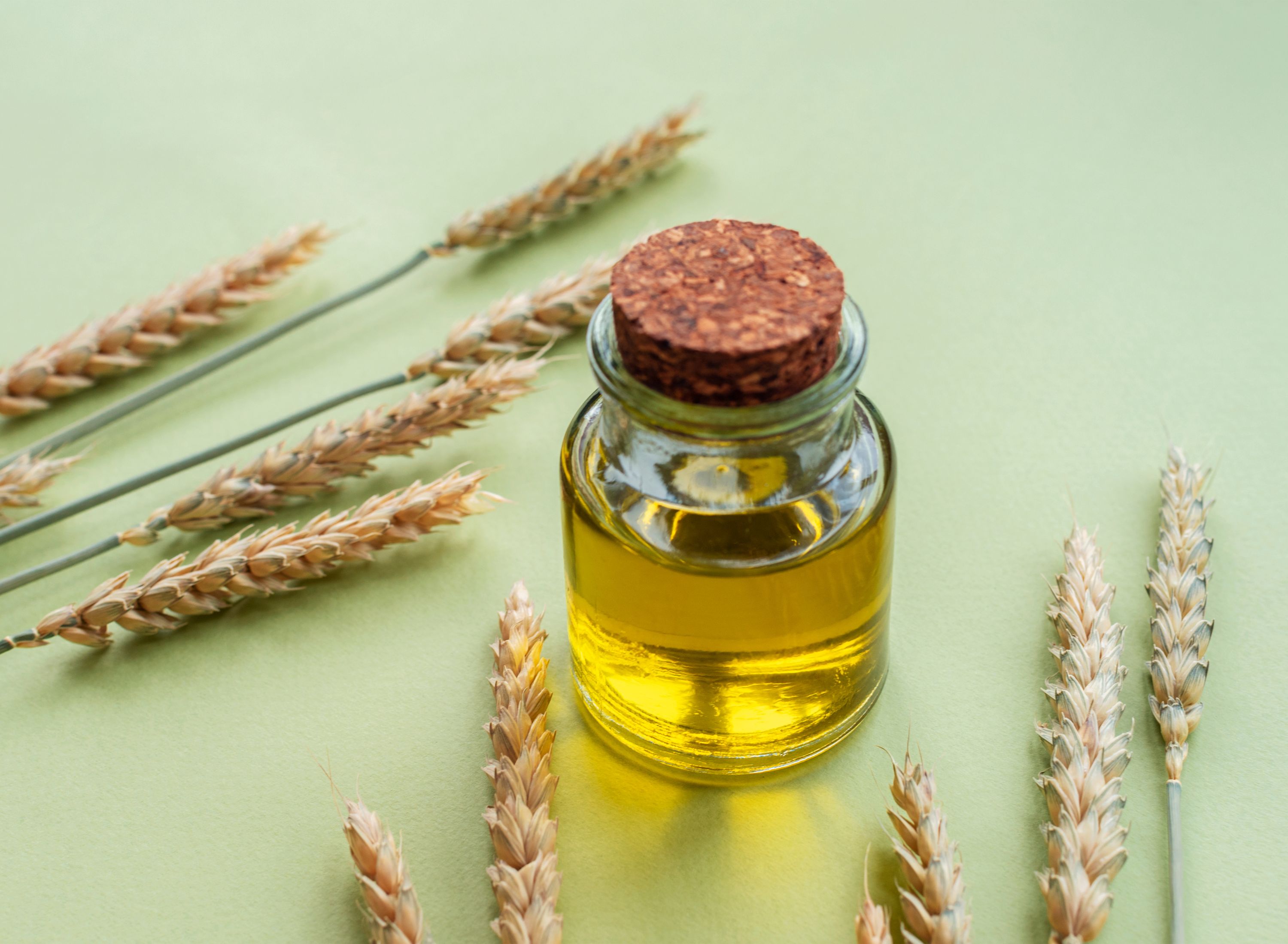 oil in a jar on a green background