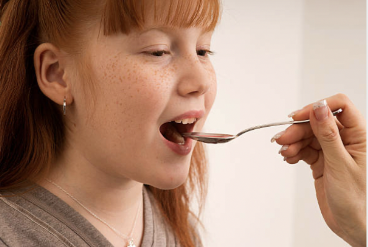 red-head-girl-eating-honey