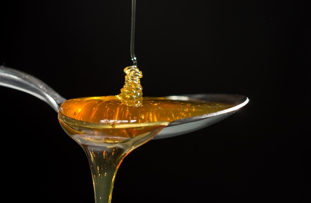 black background honey on spoon